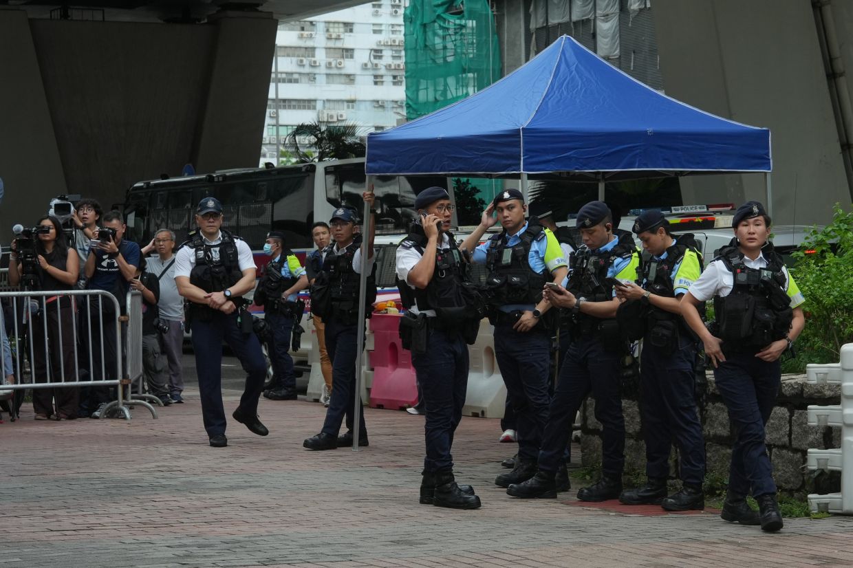 Hong Kong Woman Arrested for Seditious T-Shirt as Court Convicts Democracy Activists