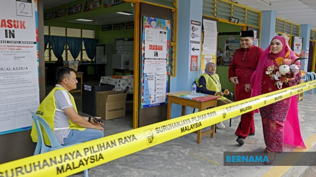 Young Bride Casts Vote in Traditional Red Attire at Negeri Sembilan Election