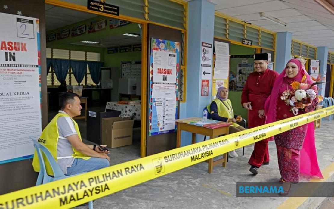 Young Bride Casts Vote in Traditional Red Attire at Negeri Sembilan Election